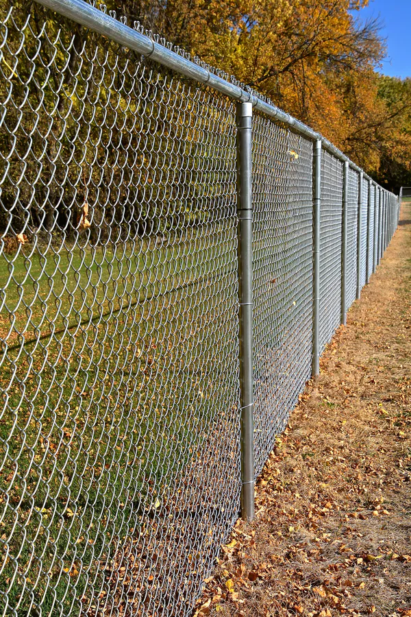 Chain link fence installation along a property line