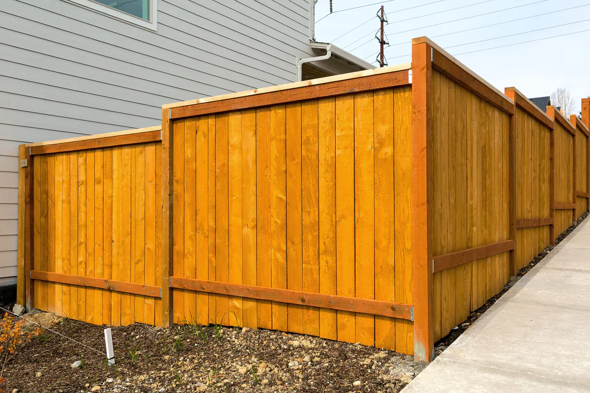 Privacy fence installed on sloped terrain