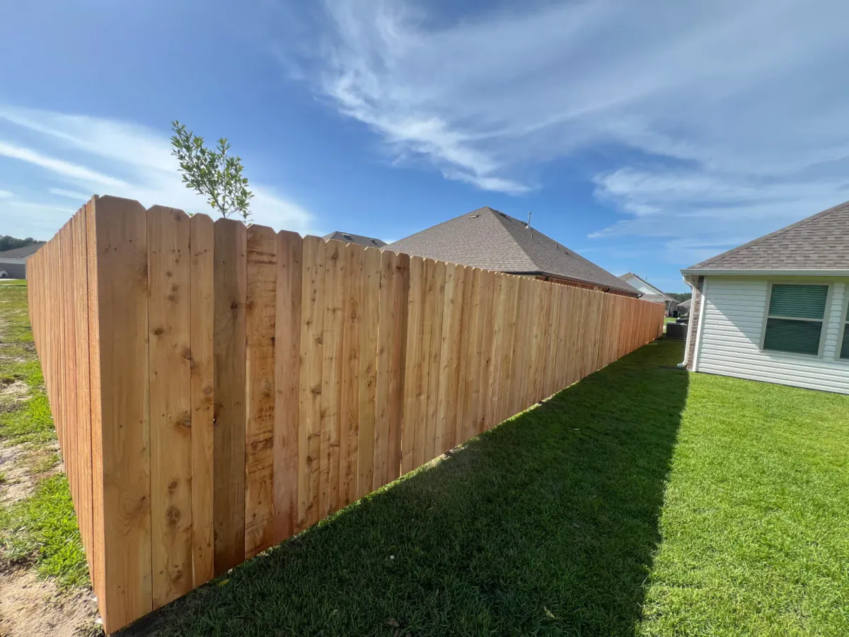 Finished wood fence surrounding a backyard